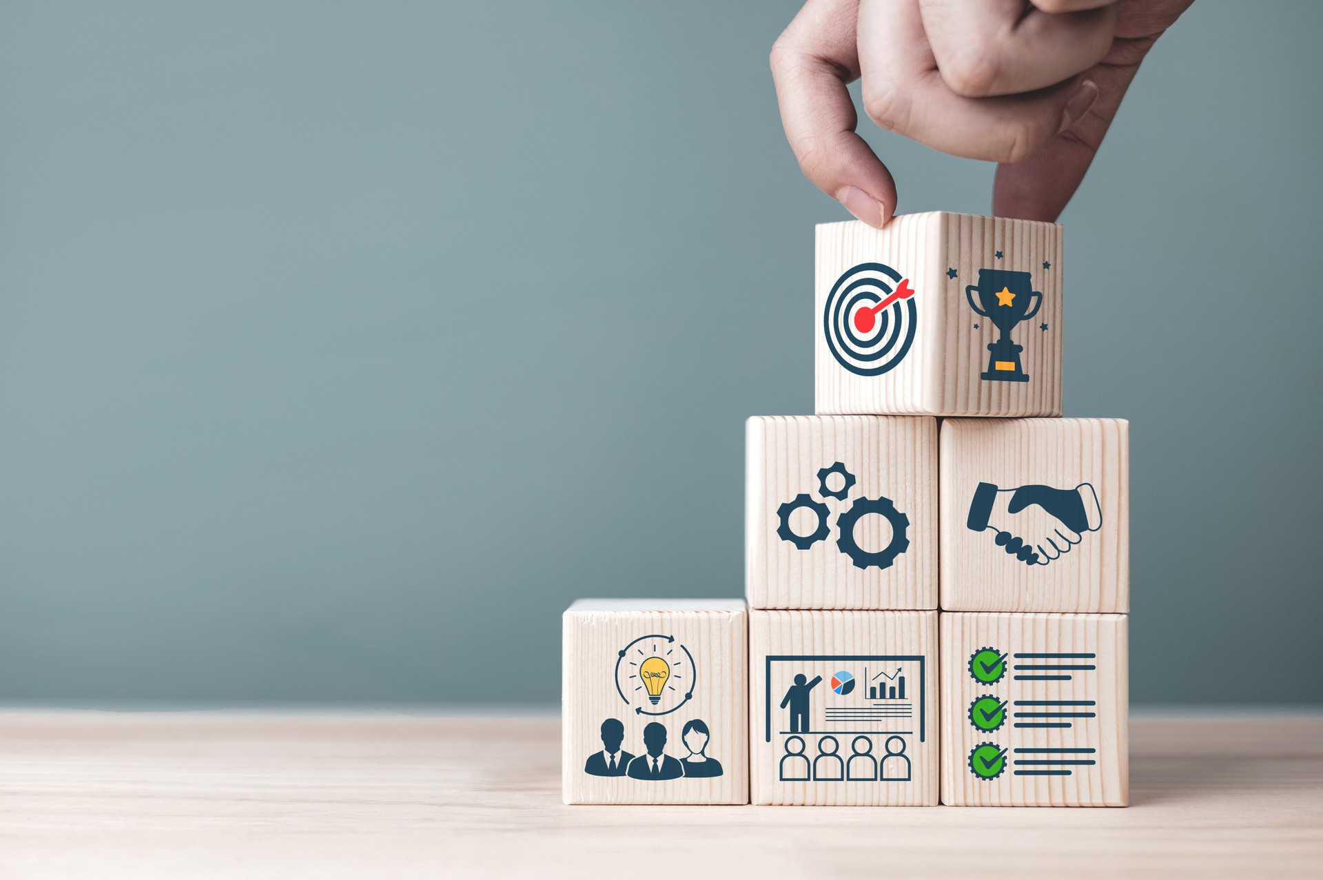 Concepts and methods for developing organizations towards success. Business icons on wooden blocks Concepts and methods for developing organizations towards success. Business icons on wooden blocks