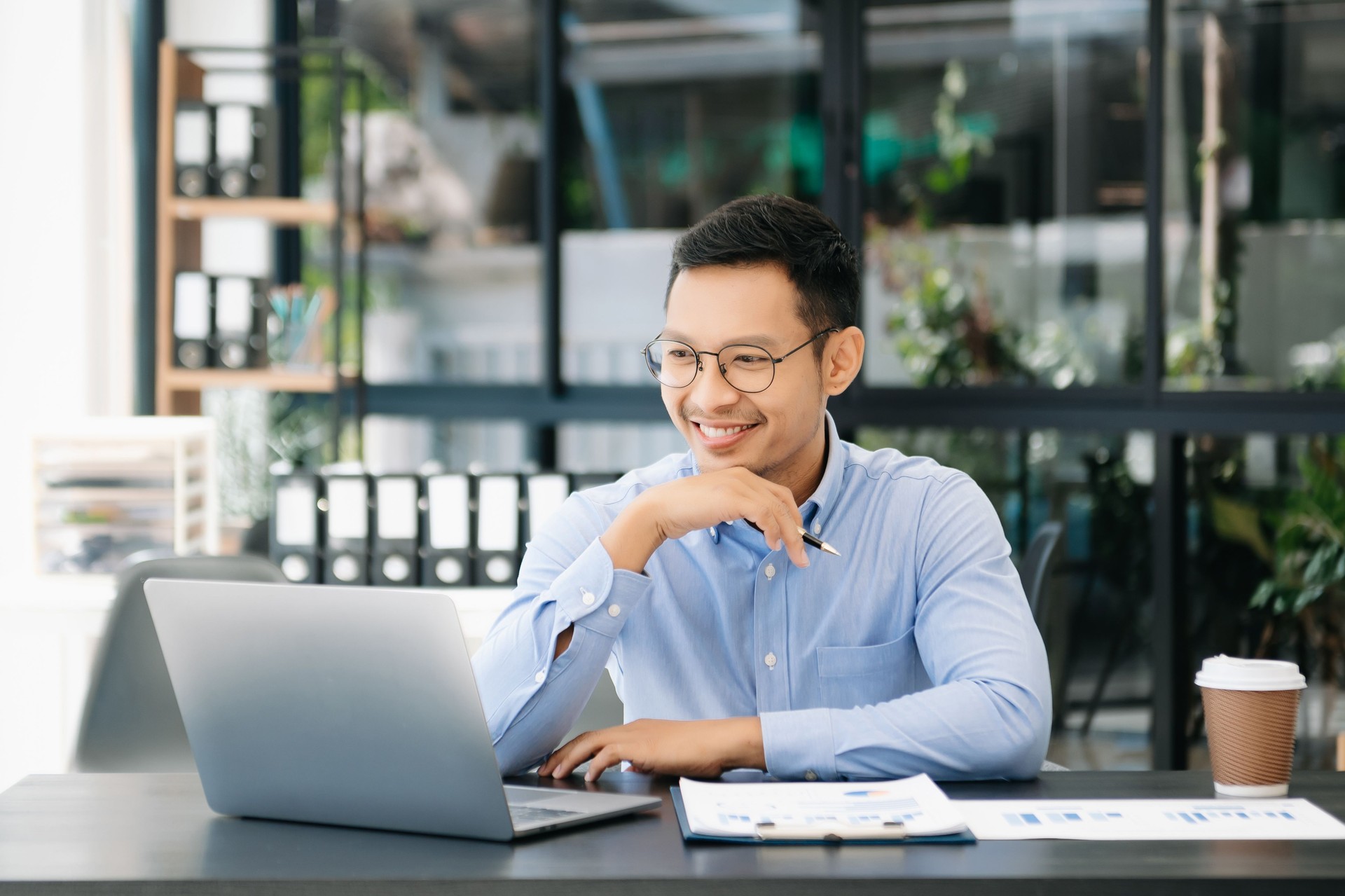 Mature business man executive manager looking at laptop watching online webinar training or having virtual meeting video conference Mature business man executive manager looking at laptop watching online webinar training or having virtual meeting video conference